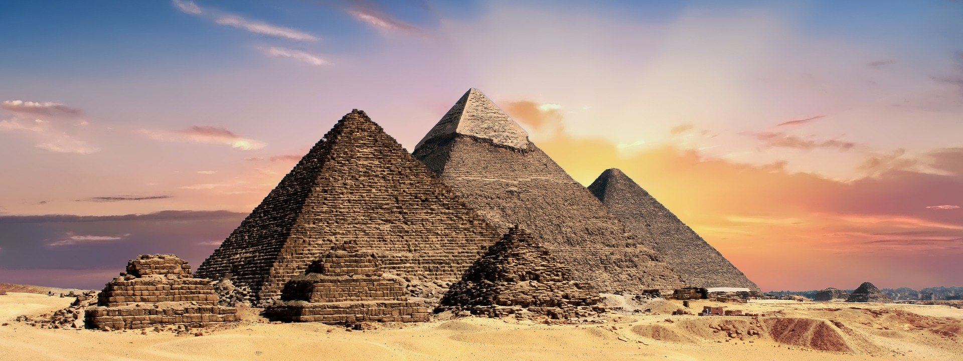 Ancient Egyptian Pyramids of Giza with covering the Sun making Sky look orange